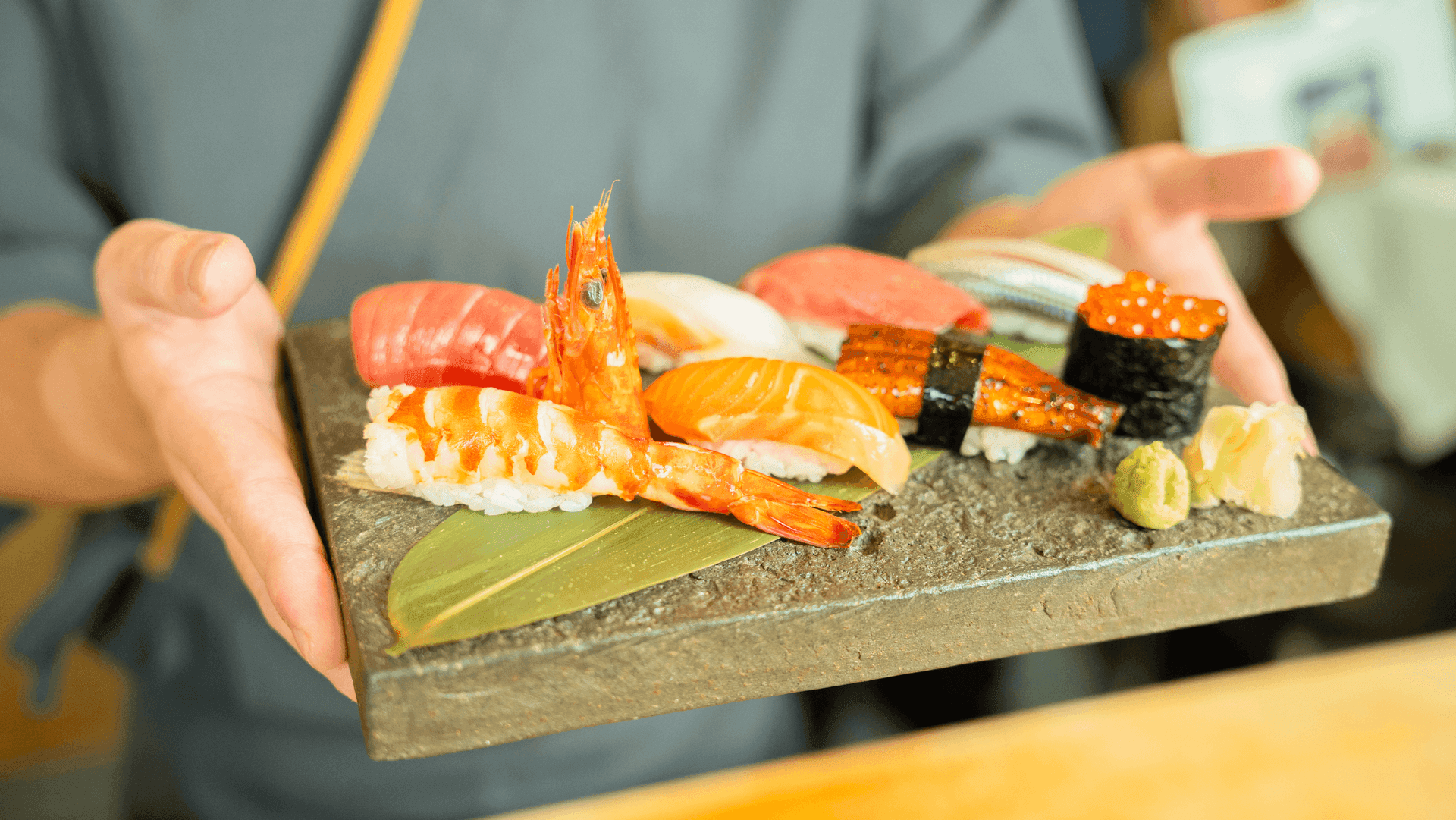 A sushi assortment being presented at the table